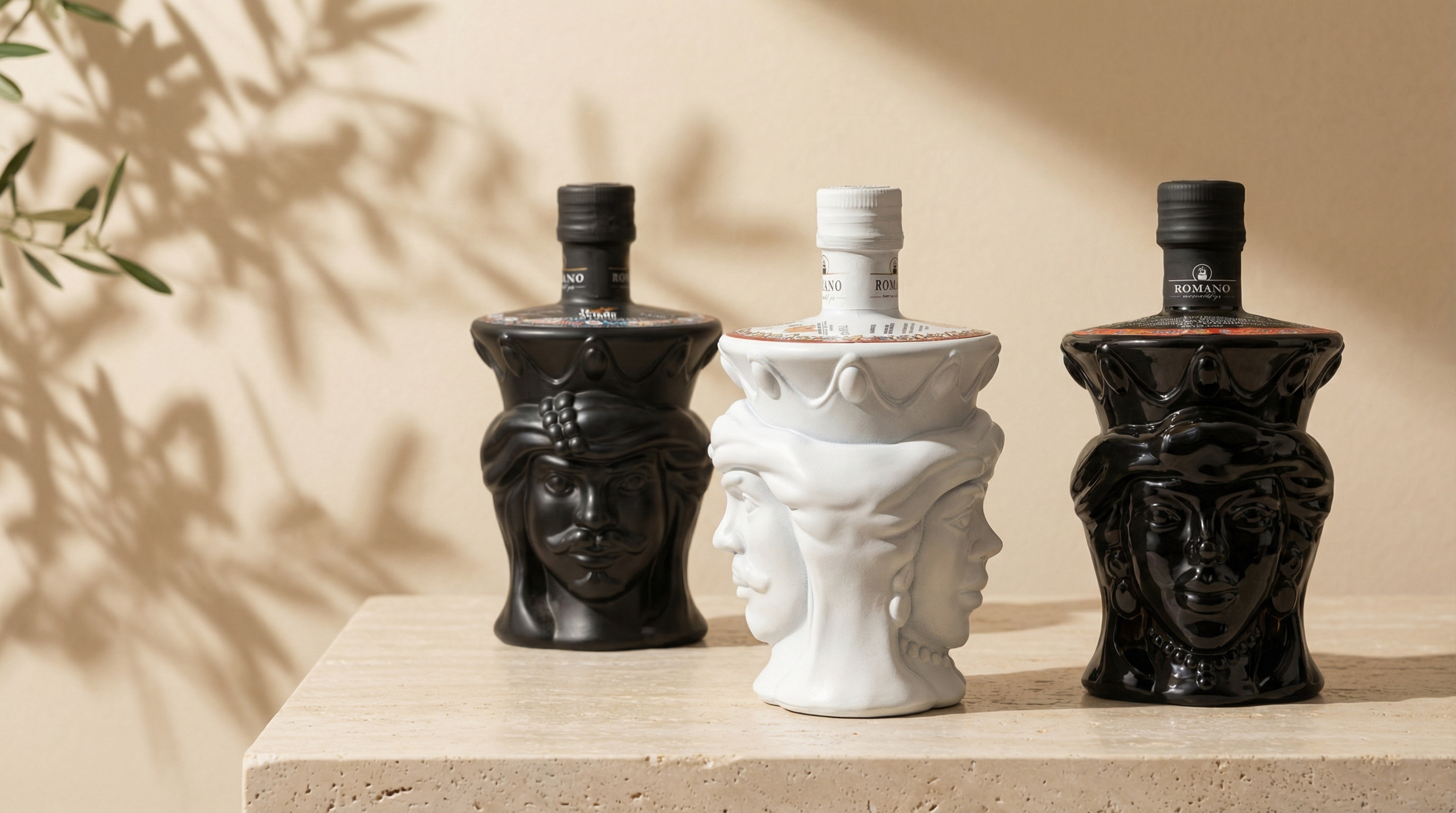 3 Teste di moro frantoio romano olio di oliva  su tavolo di travertino e albero di ulivo sullo sfondo